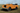 orange Land Rover Serie 3 88 inch Cabrio mit individuellem Interieur in offener Landschaft