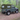 Land Rover Defender 90 mit Soft Top Verdeck in oliv grün aus Canvas im Wald. Im Hintergrund sind Bäume zu sehen. Das Verdeck hat ein Heckfenster und Seitenfenster. 