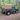 Land Rover Defender 90 Td5 Td4 mit Soft Top Verdeck in sand beige aus Canvas im Wald. Im Hintergrund sind Bäume zu sehen. Das Verdeck hat ein Heckfenster .