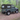 Land Rover Defender 90 mit Soft Top Verdeck in schwarz aus Canvas im Wald. Im Hintergrund sind Bäume zu sehen. Das Verdeck hat seitliche Fenster und ein Heckfenster.
