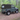 Land Rover Defender 90 Td5 Td4 mit Soft Top Verdeck in schwarz aus Canvas im Wald. Im Hintergrund sind Bäume zu sehen. Das Verdeck hat ein Heckfenster .
